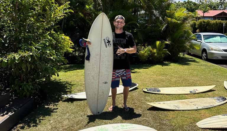 Millington with a surfboard