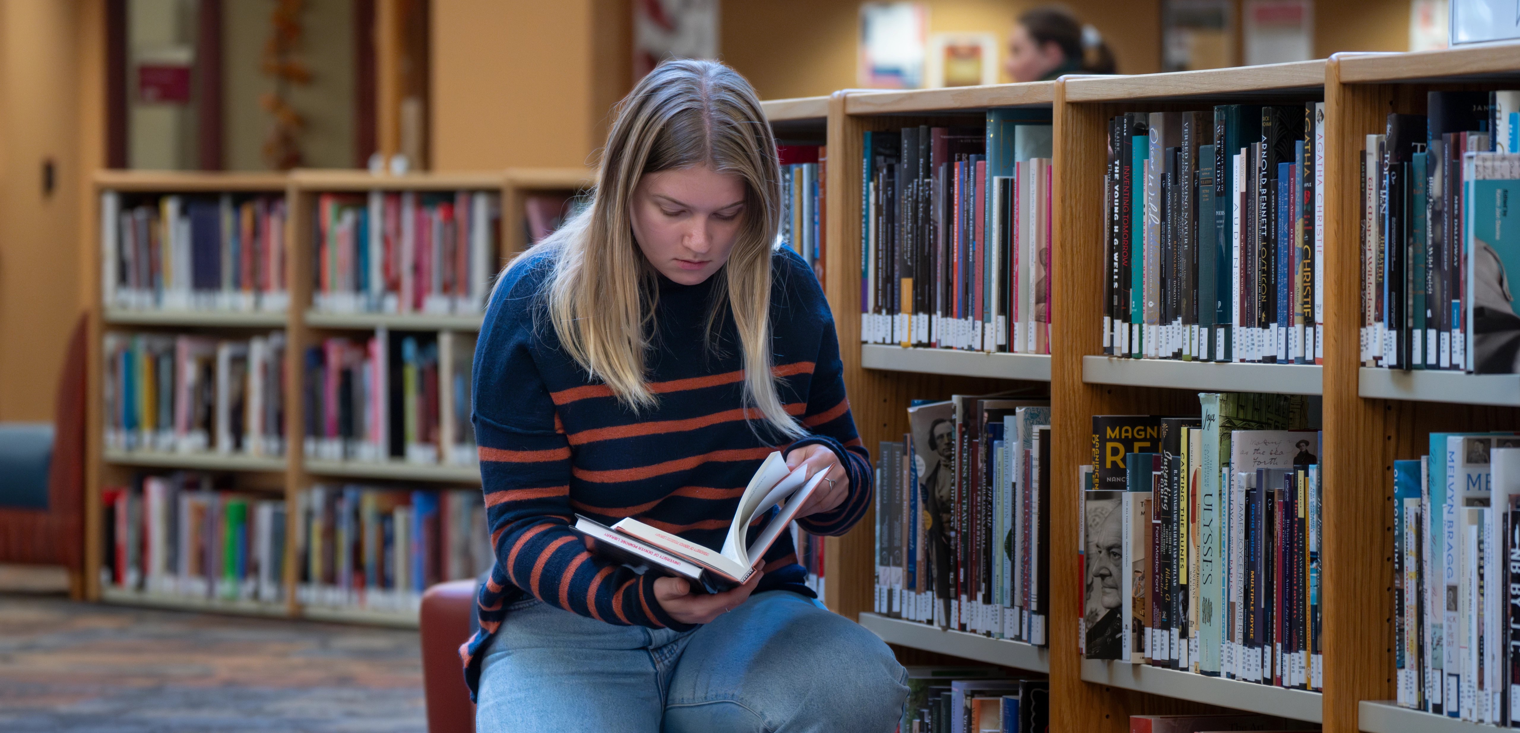 student reading in a library