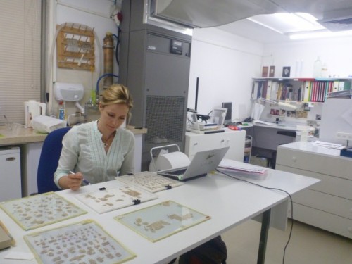 Alison Schofield works with scroll fragments at the Israel Museum.