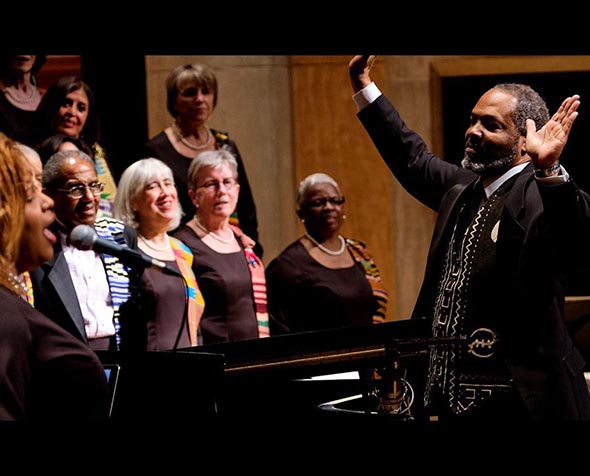 Roger Holland standing in front of choir