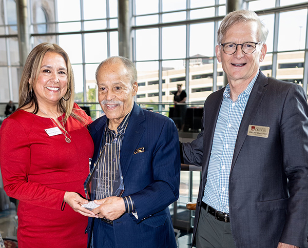 Ed Dwight (center) stands with CAHSS Dean Rhonda Gonzalez and DU Chancellor Jeremy Haefner after receiving the CAHSS Lifetime Achievement Award.