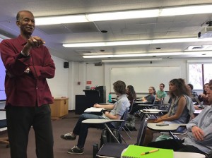 Moses Brewer speaking in front of a class