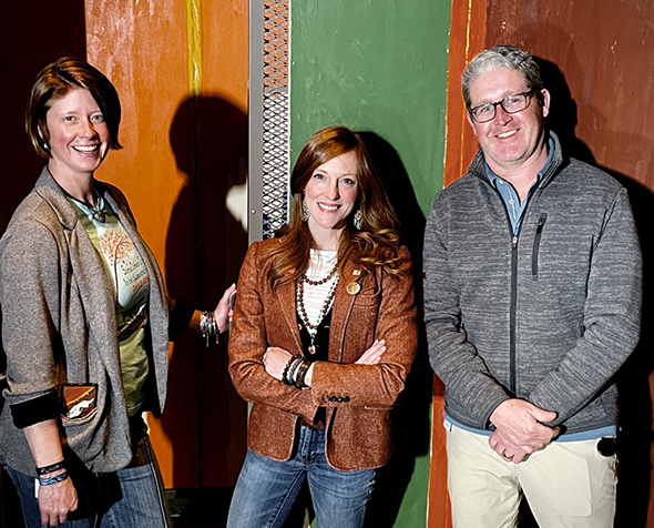Museum Studies MA student Celina Grey Taylor stands in the conservation area of the Clyfford Still museum with conservation team Michal Mikesell and James Squires. 