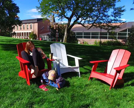 Student sitting in a chair on campus