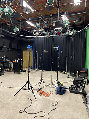 Three lighting units stand in the MFJS Studio