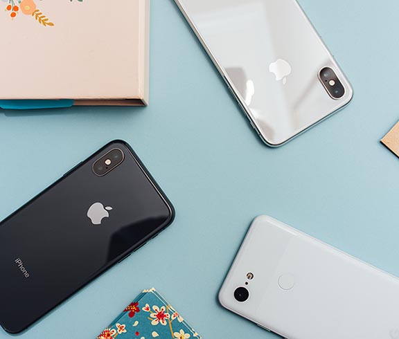 notebook, iphone, google pixel on blue background