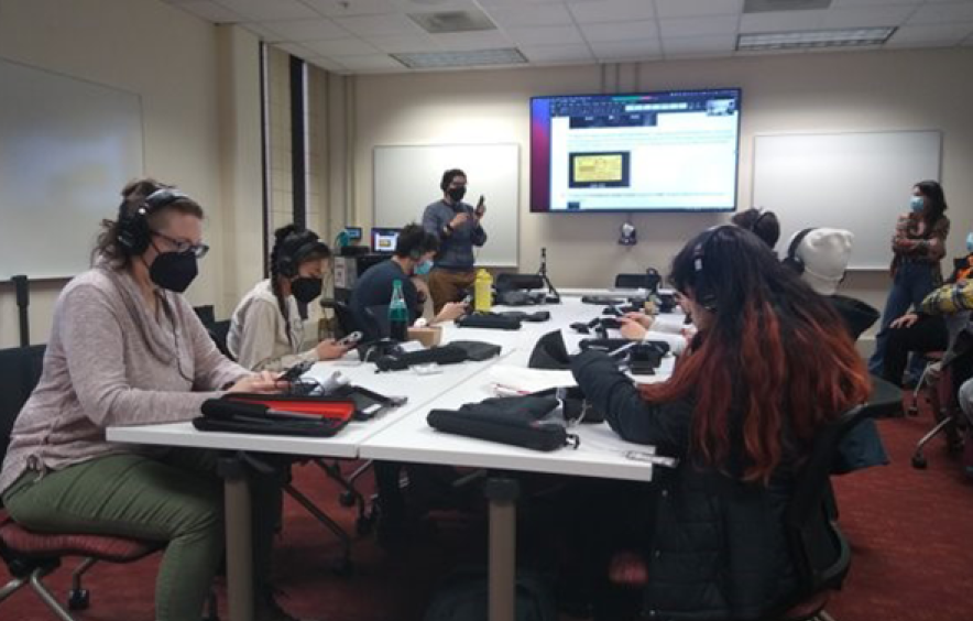 Professor Carlos Jimenez teaches a group of students who are participating in Hidden Voices.