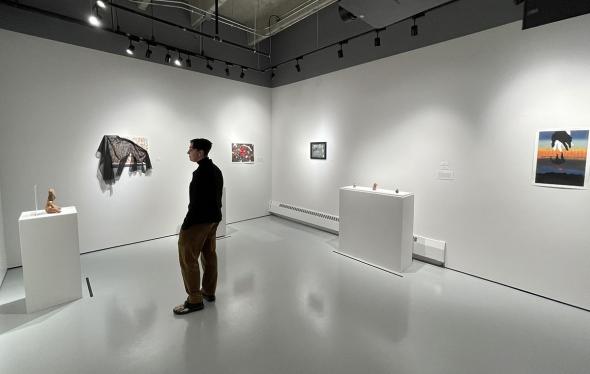 Sydney Barofsy stands in the exhibit they curated at the Davis Gallery.