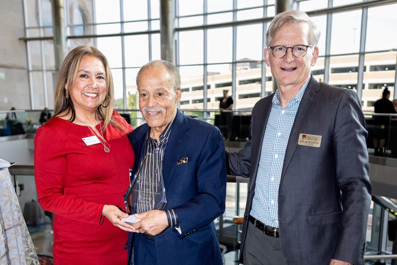 Ed Dwight (center) stands with CAHSS Dean Rhonda Gonzalez and DU Chancellor Jeremy Haefner after receiving the CAHSS Lifetime Achievement Award.