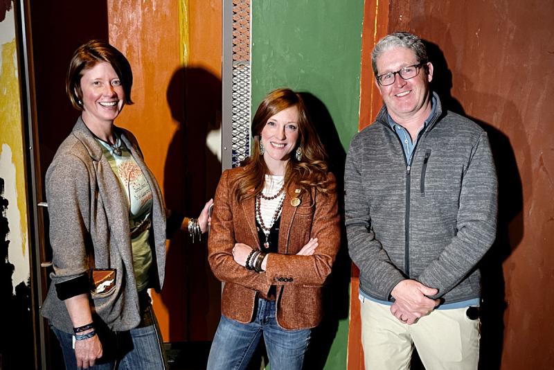 Museum Studies MA student Celina Grey Taylor stands in the conservation area of the Clyfford Still museum with conservation team Michal Mikesell and James Squires. 