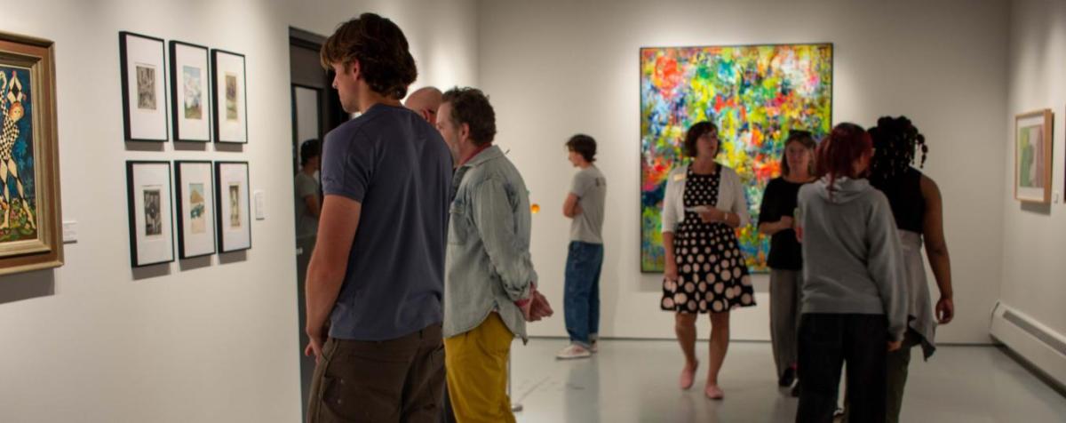 crowd of people in gallery during an opening reception