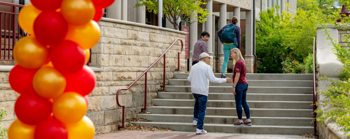 alumni talking to someone