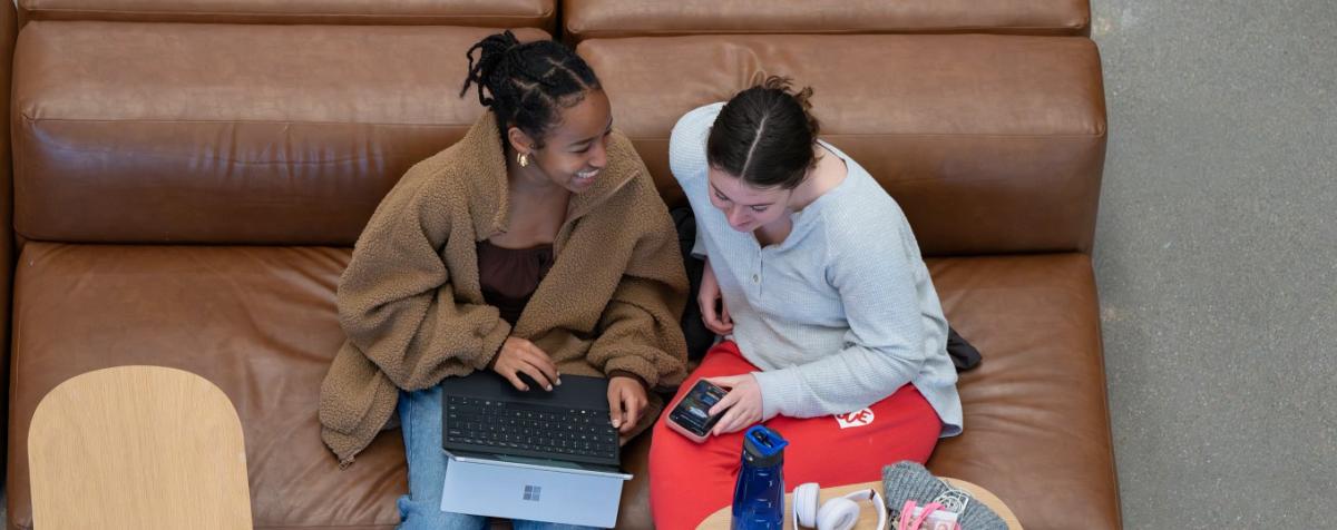 Students talking & laughing on a couch