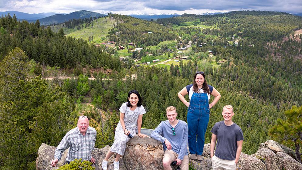 group of students surveying mountain landscape